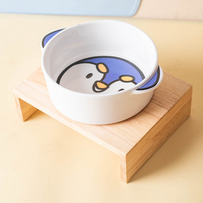Penguin ceramic pet bowl on a separate natural-toned stand; stand not included