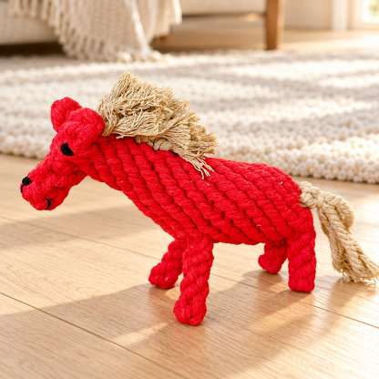 Red Rope Buddy Horse dog toy with cream rope mane and tail on pale timber